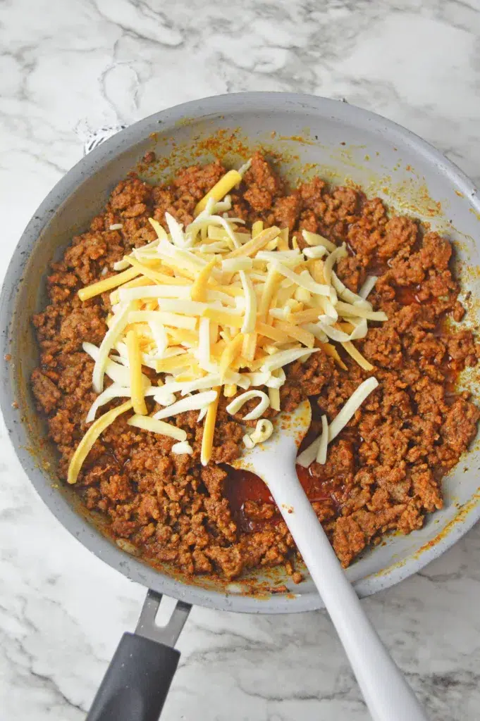 cheese and taco meat in a skillet